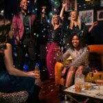 a group of people celebrating with confetti and balloons